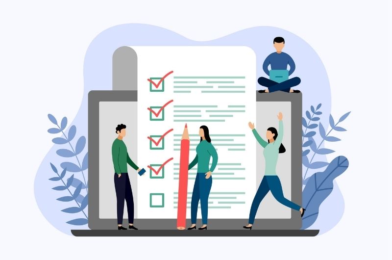 An image of 4 people working together to complete a list of tasks.